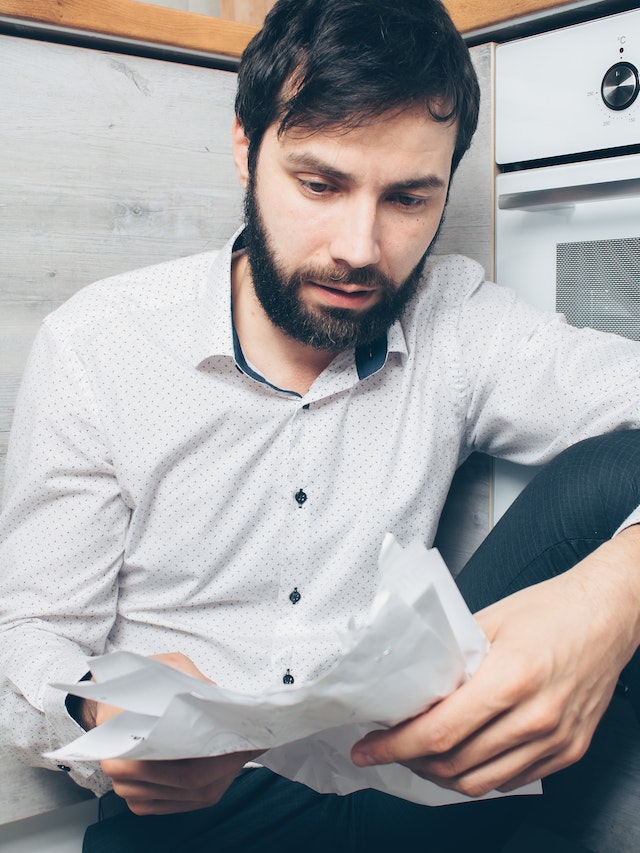 Man stressed reading paper